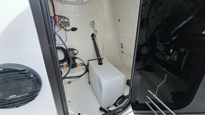 Slide: The Image of 2024 Sea Pro 210 Bay boat interior showing wiring and equipment setup. - 5