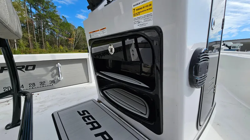 Slide: The Image of 2024 Sea Pro 210 Bay boat interior with storage compartments and Sea Pro branding. - 8