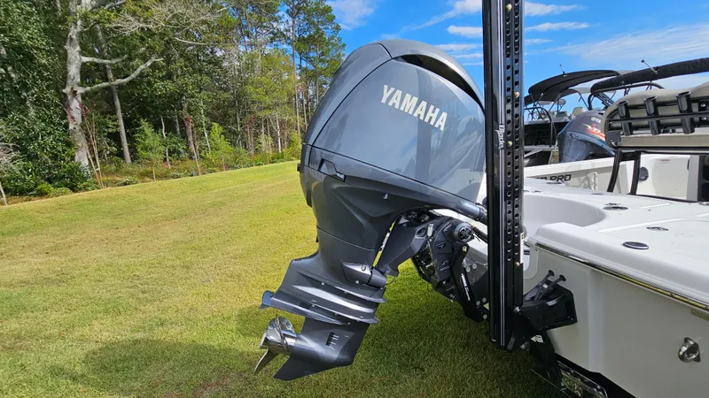 Slide: The Image of 2024 Sea Pro 210 Bay boat with Yamaha outboard motor on grassy area. - 9