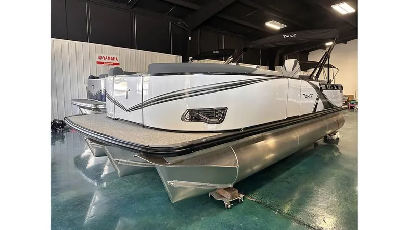 Slide: The Image of 2025 Tahoe Pontoon LTZ Versatile Rear Lounger in showroom, showcasing sleek design and modern features. - 0