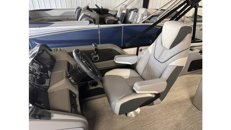 Slide: The Image of 2025 Tahoe Pontoon LTZ Versatile Rear Lounger interior with captain's chair and control panel. - 7