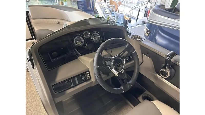 Slide: The Image of 2025 Tahoe Pontoon LTZ Versatile Rear Lounger dashboard with steering wheel and gauges. - 8
