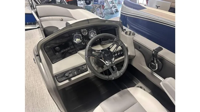 Slide: The Image of 2025 Tahoe Pontoon LTZ Cruise Rear Bench interior with steering wheel and dashboard controls. - 10