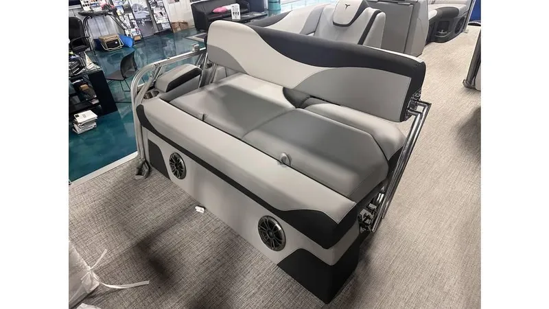 Slide: The Image of 2025 Tahoe Pontoon LTZ Cruise Rear Bench, gray and black seating with integrated speakers. - 6