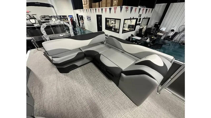 Slide: The Image of 2025 Tahoe Pontoon LTZ Cruise Rear Bench with sleek gray seating in showroom. - 7