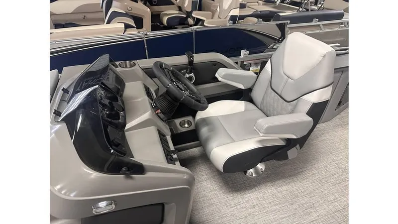 Slide: The Image of 2025 Tahoe Pontoon LTZ Cruise Rear Bench helm with modern steering and comfortable seating. - 9