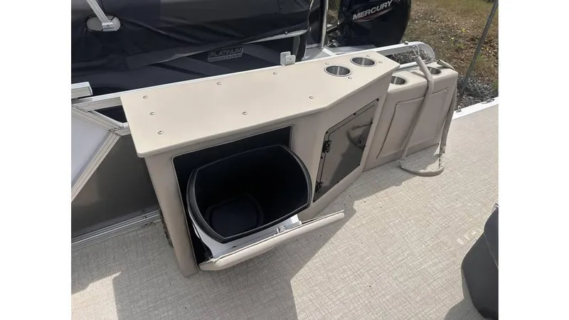 Slide: The Image of 2025 Tahoe Pontoon LTZ Cruise Rear Bench with open storage compartment and cup holders. - 2