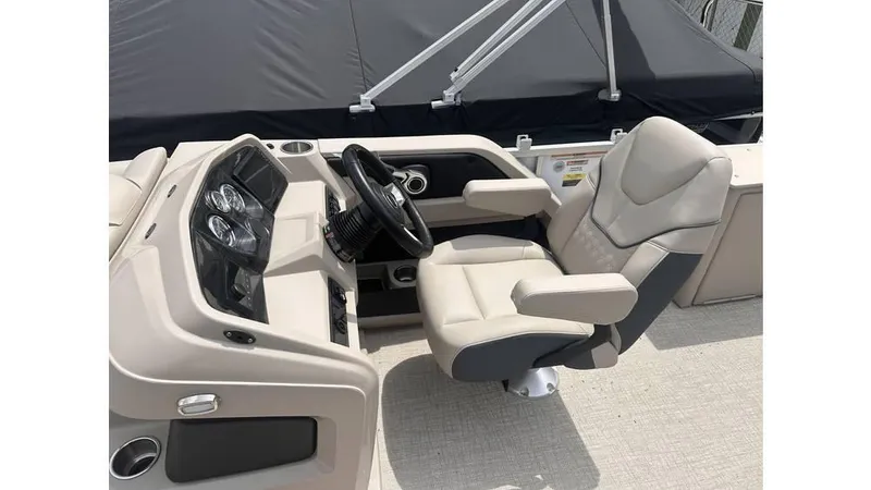 Slide: The Image of 2025 Tahoe Pontoon LTZ Cruise Rear Bench helm with luxurious captain's chair and modern dashboard. - 7
