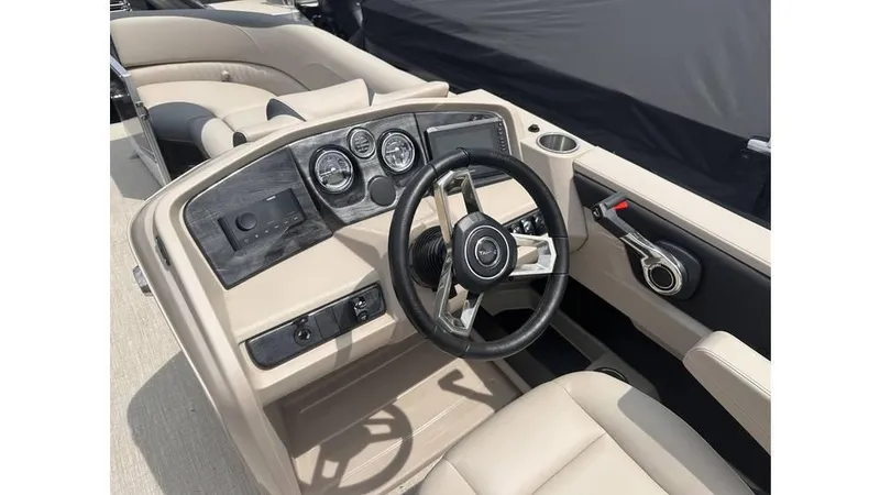 Slide: The Image of 2025 Tahoe Pontoon LTZ Cruise Rear Bench dashboard with steering wheel and controls. - 8