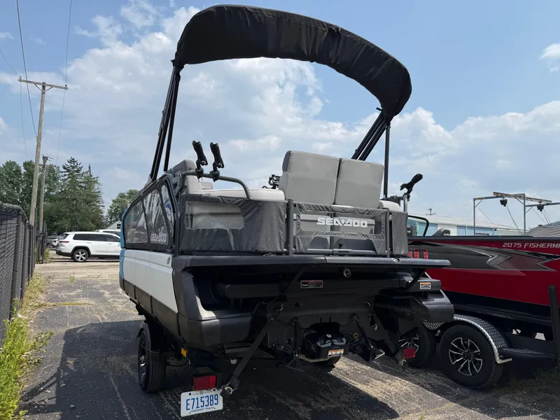 Slide: The Image of 2022 Sea-Doo Switch Cruise 18' - 170HP boat with canopy, parked outdoors. - 3