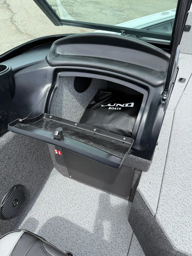 Slide: The Image of 2025 Lund Fisherman 2075 boat interior with storage compartment open. - 12