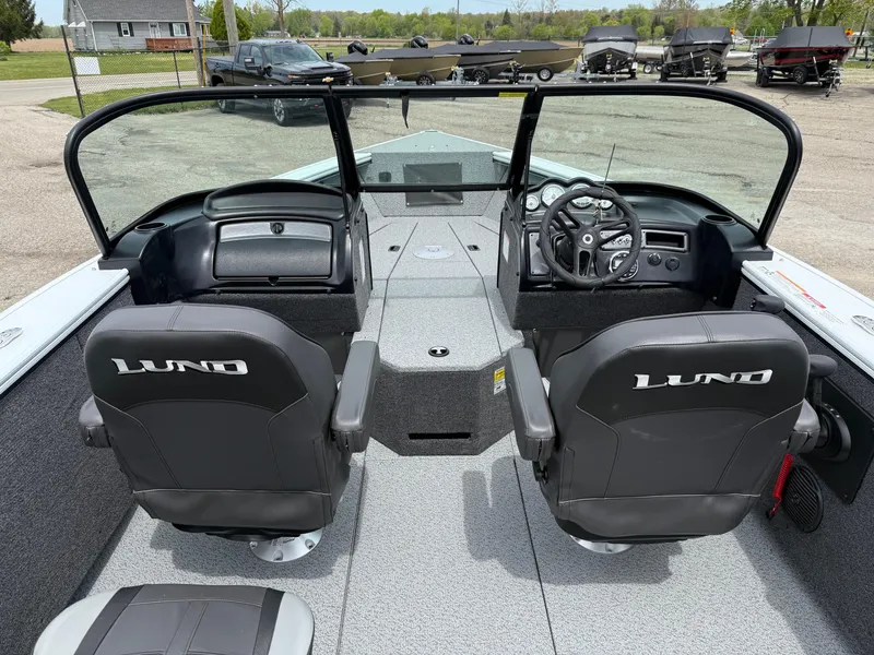 Slide: The Image of 2025 Lund Fisherman 2075 boat interior with dual seats and steering console. - 4