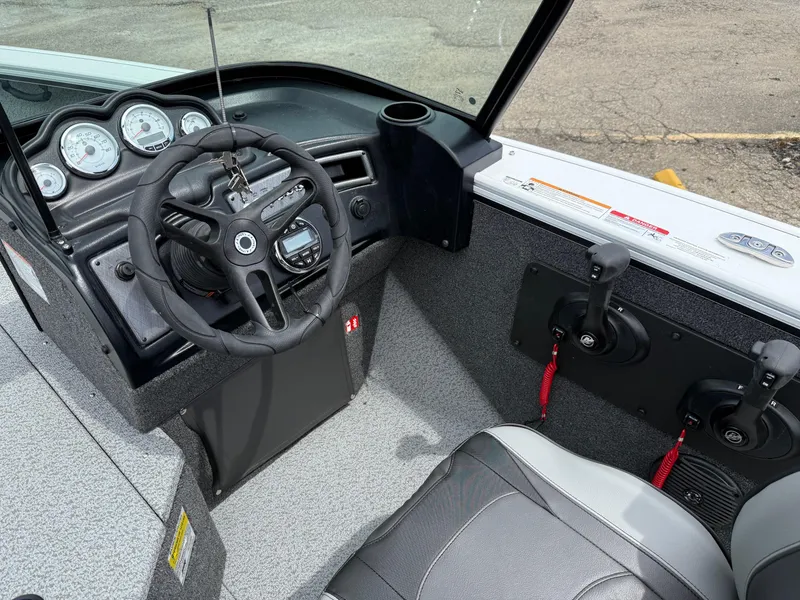 Slide: The Image of 2025 Lund Fisherman 2075 boat interior with steering wheel and control panel. - 5
