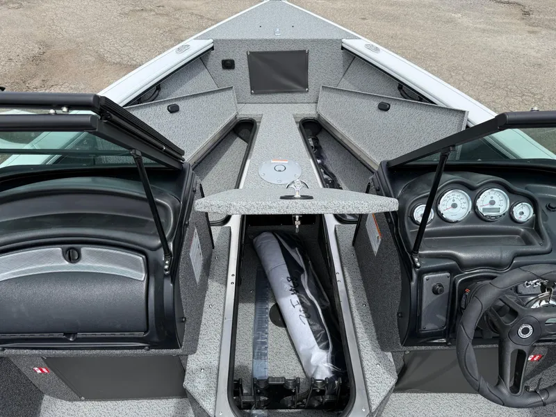 Slide: The Image of 2025 Lund Fisherman 2075 boat interior with open storage compartments and dashboard view. - 6