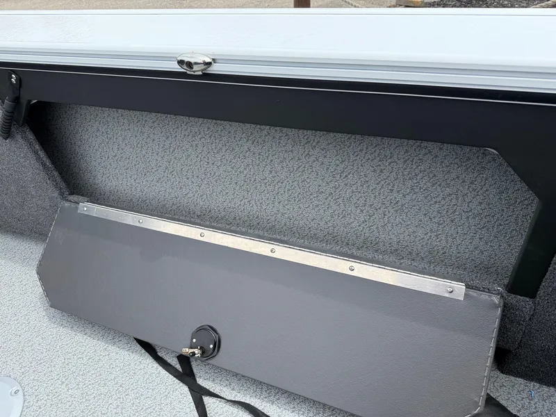 Slide: The Image of 2025 Lund Fisherman 2075 boat interior detail with storage compartment and latch. - 7