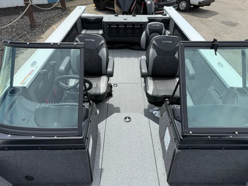 Slide: The Image of 2025 Lund Fisherman 2075 boat interior with dual seats and windshield. - 8