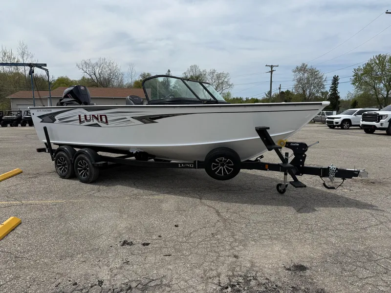 Slide: The Image of 2025 Lund Fisherman 2075 boat on trailer in parking lot. - 9