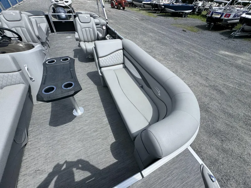 Slide: The Image of 2022 Bennington 22 SSR pontoon boat interior with gray seating and table. - 14