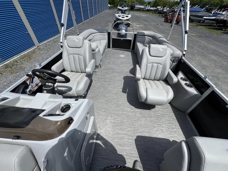 Slide: The Image of 2022 Bennington 22 SSR pontoon boat interior with plush seating and steering console. - 15