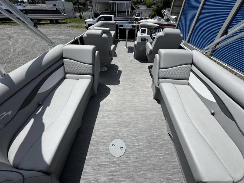 Slide: The Image of 2022 Bennington 22 SSR pontoon boat interior with gray seating and steering console. - 19