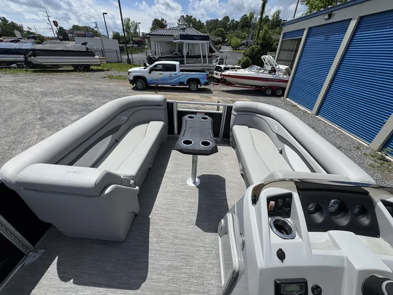 Slide: The Image of 2022 Bennington 22 SSR pontoon boat interior with gray seating and control panel. - 20