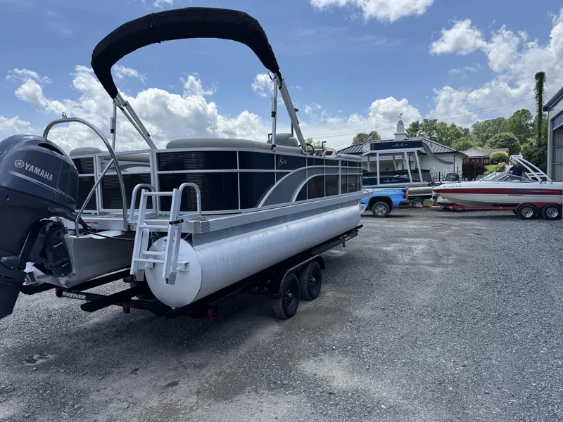 Slide: The Image of 2022 Bennington 22 SSR pontoon boat with Yamaha motor on a trailer, parked outdoors. - 3