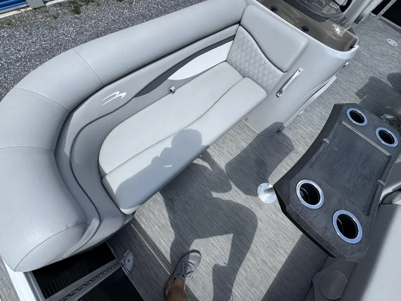 Slide: The Image of 2022 Bennington 22 SSR boat interior with gray seating and cup holders. - 4