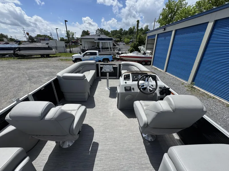 Slide: The Image of 2022 Bennington 22 SSR pontoon boat interior with plush seating and steering console. - 6