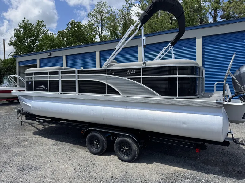Slide: The Image of 2022 Bennington 22 SSR pontoon boat on trailer, parked outdoors. - 9