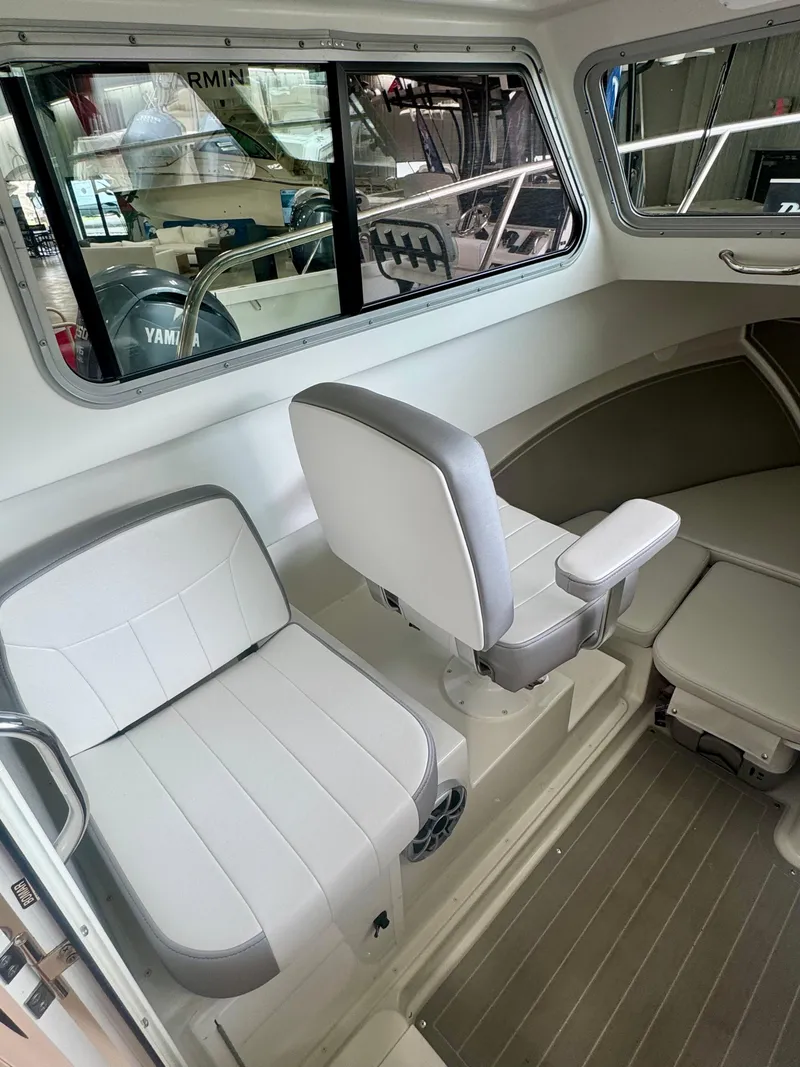 Slide: The Image of 2025 Parker 2420 Sport Cabin interior with white seating and modern design. - 13