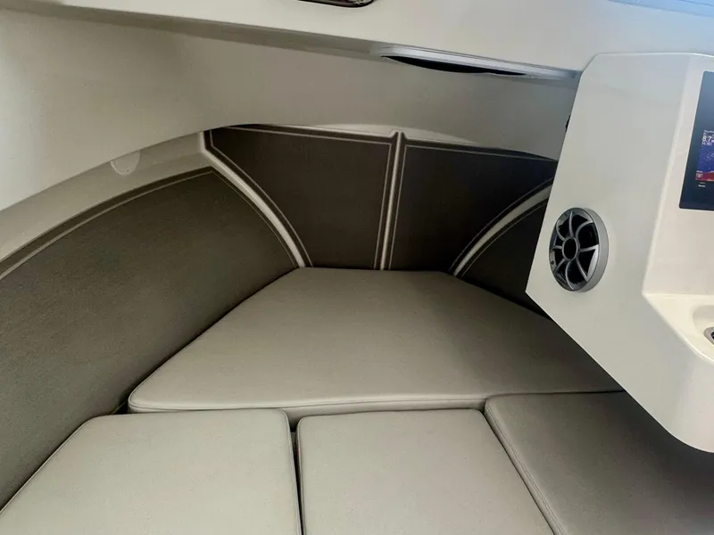 Slide: The Image of 2025 Parker 2420 Sport Cabin interior with cushioned seating and speaker system. - 14
