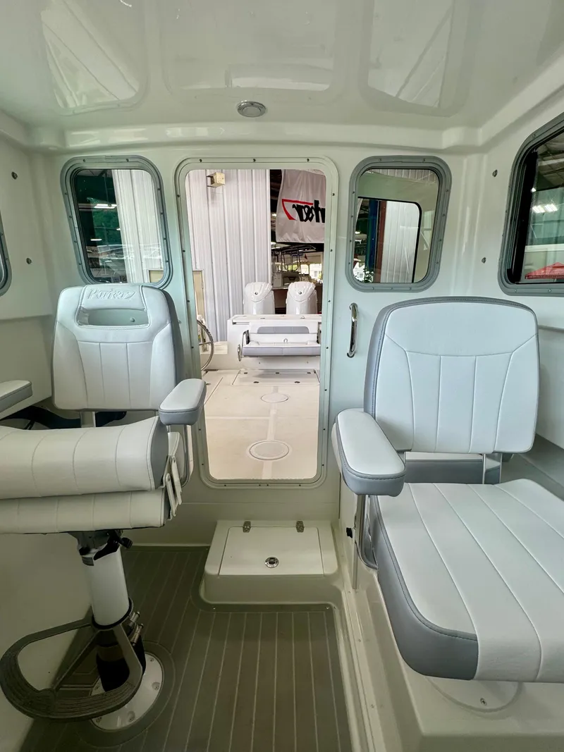 Slide: The Image of 2025 Parker 2420 Sport Cabin interior with modern seating and sleek design. - 16