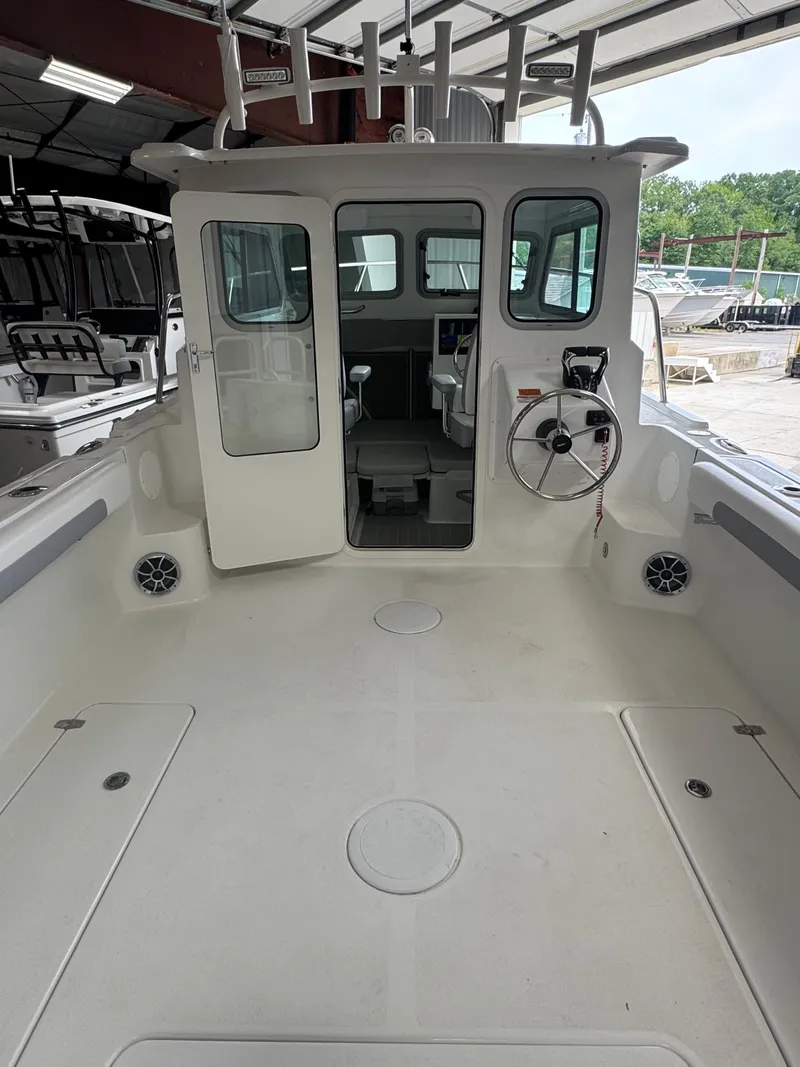 Slide: The Image of 2025 Parker 2420 Sport Cabin boat interior, featuring spacious deck and modern cabin design. - 7