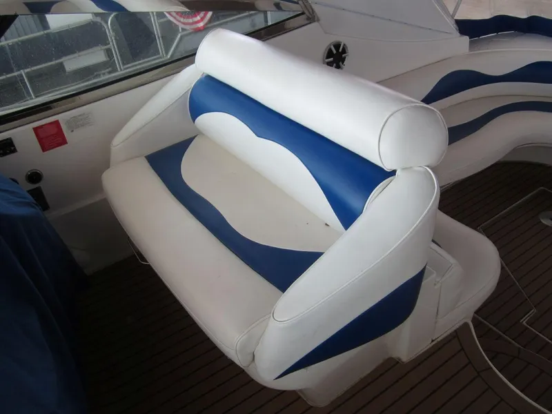 Slide: The Image of 2000 Cruisers Yachts 4270 Express interior with blue and white seating. - 12