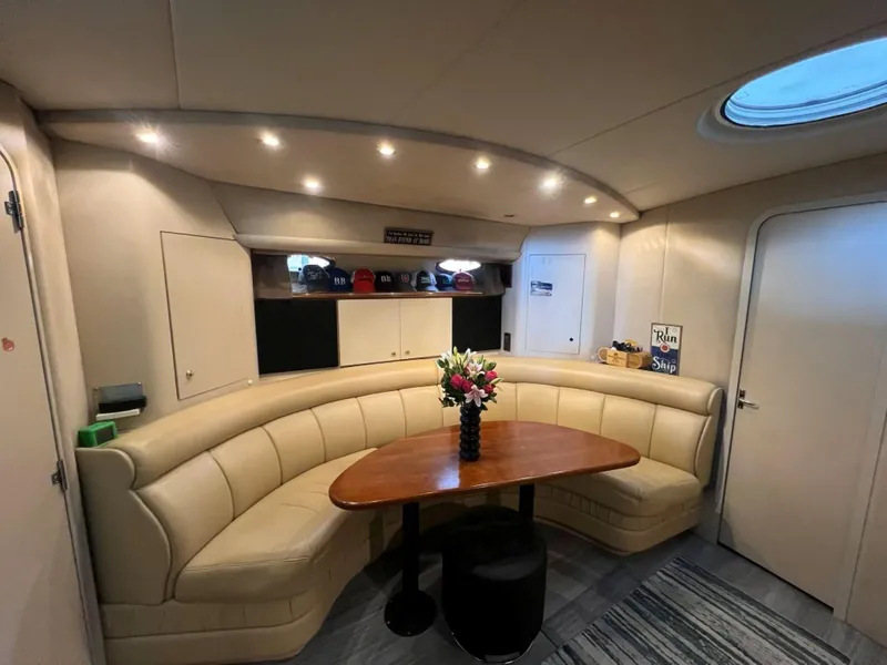 Slide: The Image of Luxurious interior of 2000 Cruisers Yachts 4270 Express with elegant seating and table. - 15