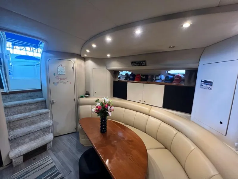Slide: The Image of Interior of 2000 Cruisers Yachts 4270 Express with elegant seating and dining area. - 16
