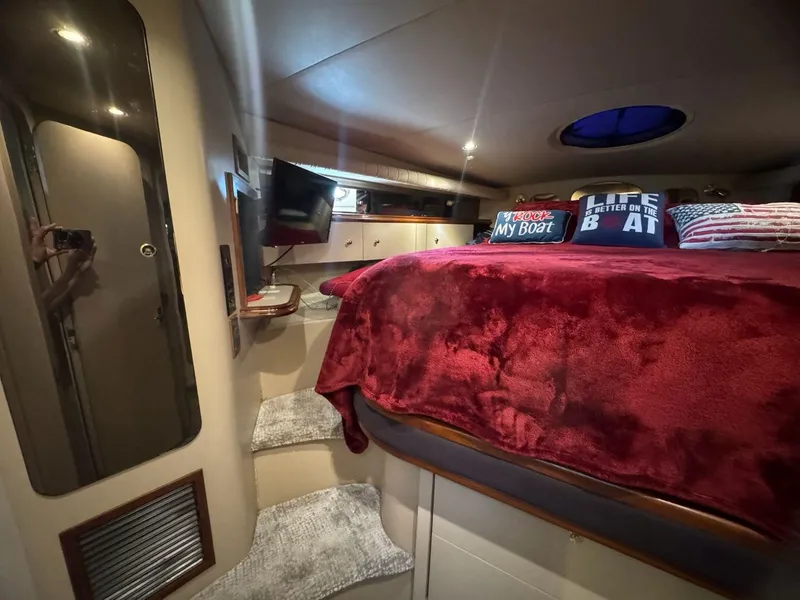 Slide: The Image of Luxurious cabin interior of 2000 Cruisers Yachts 4270 Express with plush bedding and cozy decor. - 18