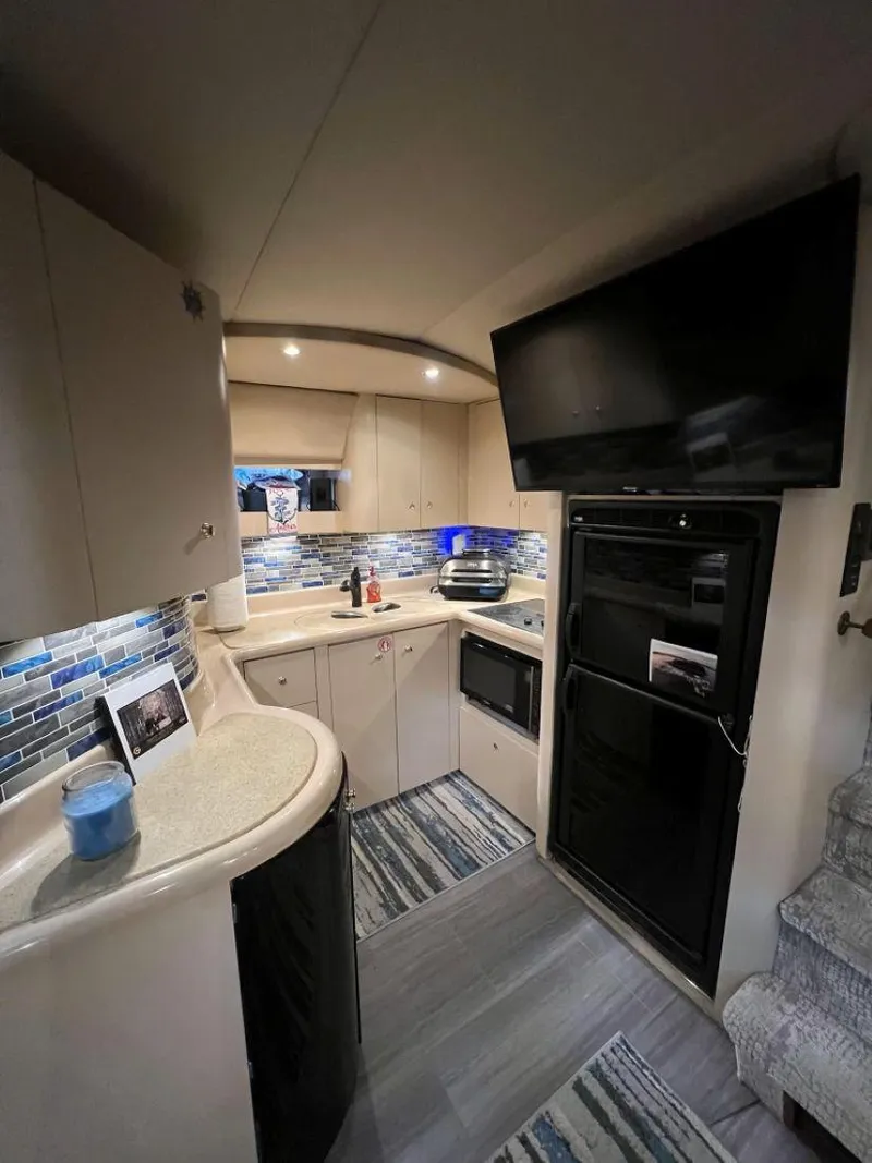 Slide: The Image of Interior of 2000 Cruisers Yachts 4270 Express with modern kitchen and stylish decor. - 24