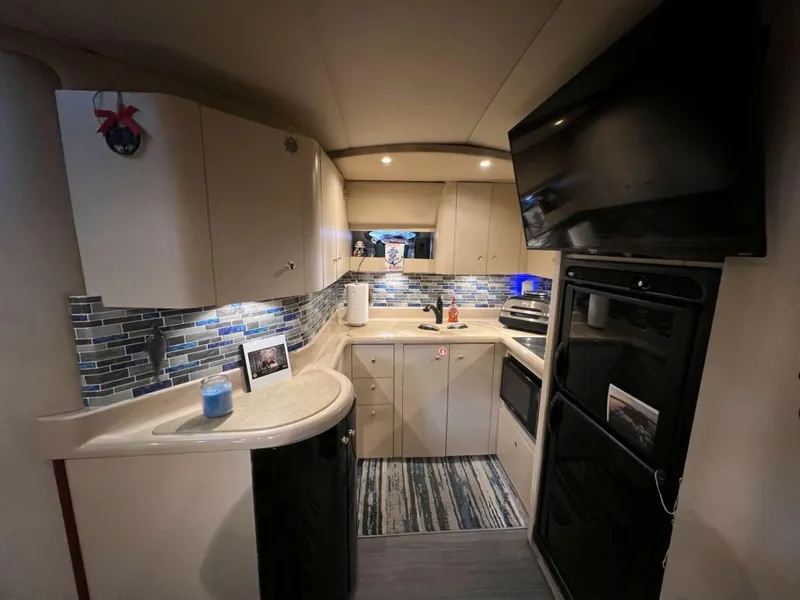 Slide: The Image of Interior of 2000 Cruisers Yachts 4270 Express with modern kitchen and sleek cabinetry. - 25