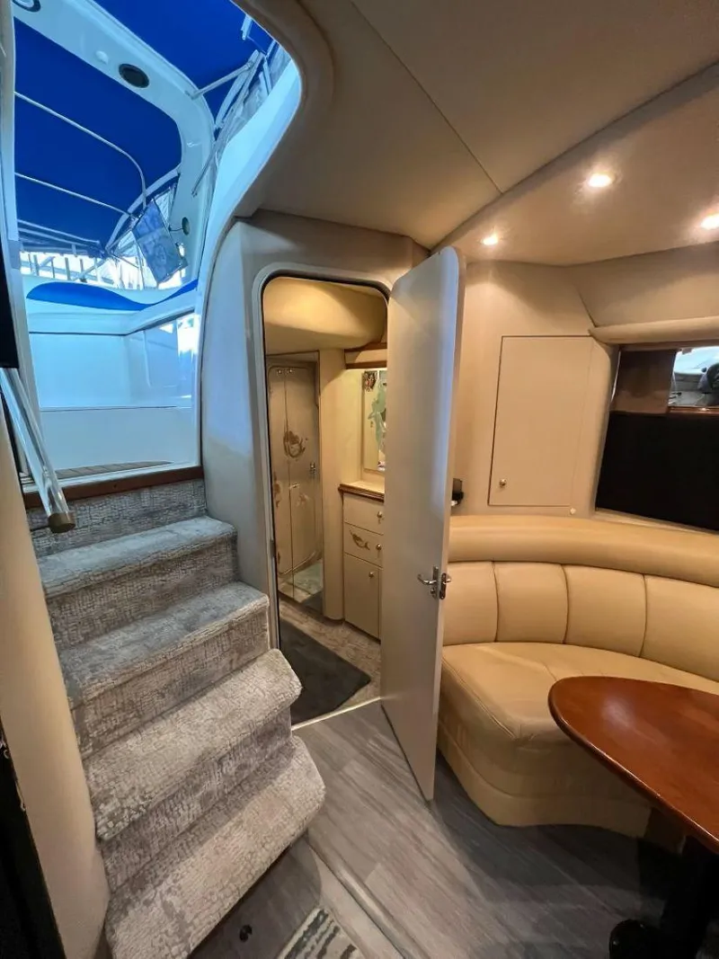 Slide: The Image of 2000 Cruisers Yachts 4270 Express interior with stairs, seating, and cabin view. - 27