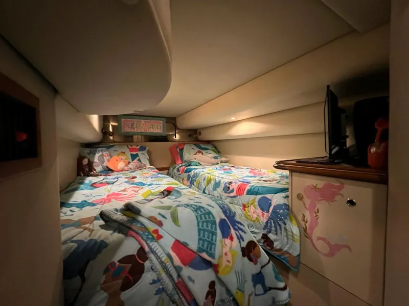 Slide: The Image of Cozy twin beds in 2000 Cruisers Yachts 4270 Express cabin with colorful bedding. - 29