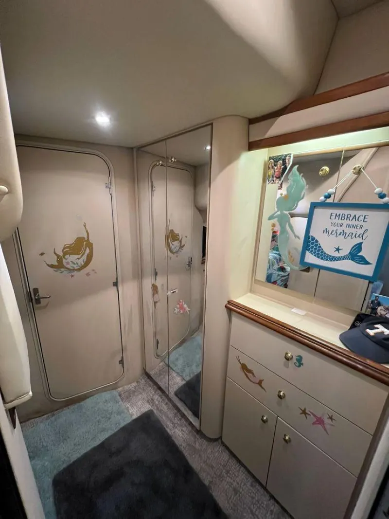 Slide: The Image of Interior of 2000 Cruisers Yachts 4270 Express with mermaid-themed decor and mirrored closet. - 31
