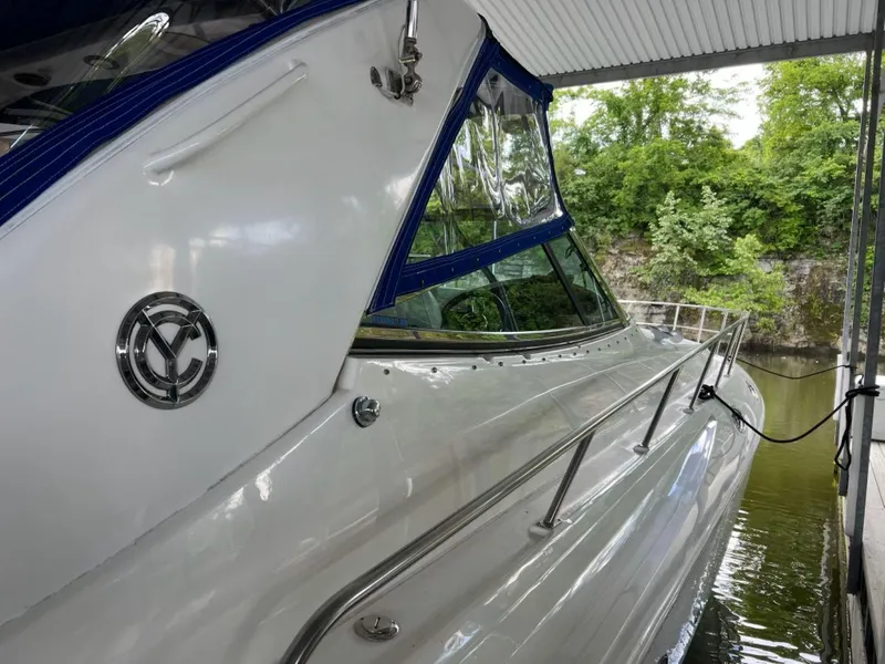 Slide: The Image of 2000 Cruisers Yachts 4270 Express docked, featuring sleek design and blue accents. - 38