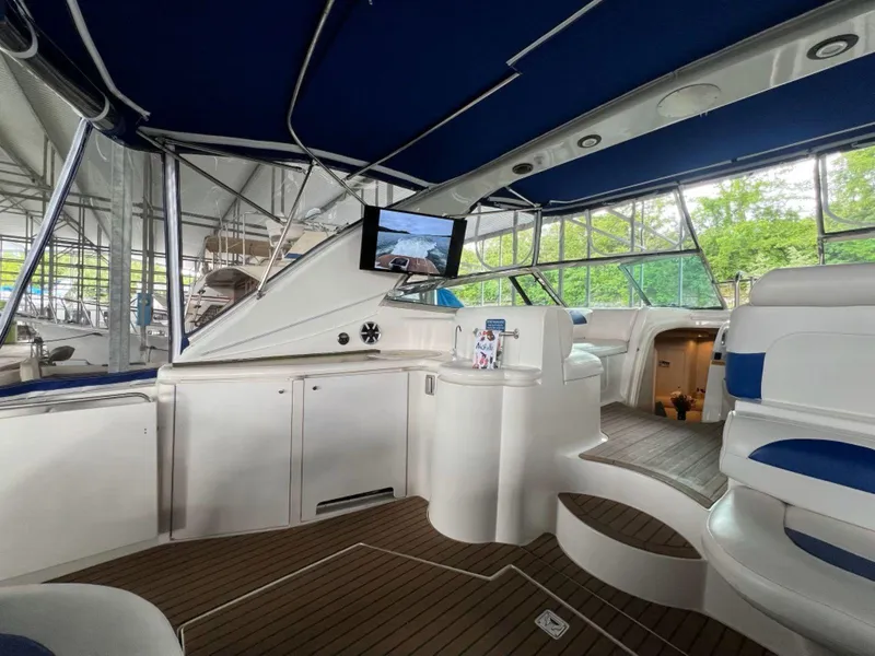 Slide: The Image of 2000 Cruisers Yachts 4270 Express interior with blue canopy and modern amenities. - 8