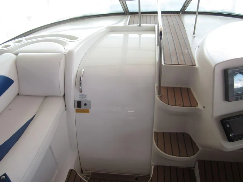 Slide: The Image of 2000 Cruisers Yachts 4270 Express interior with white seating and wooden steps. - 14