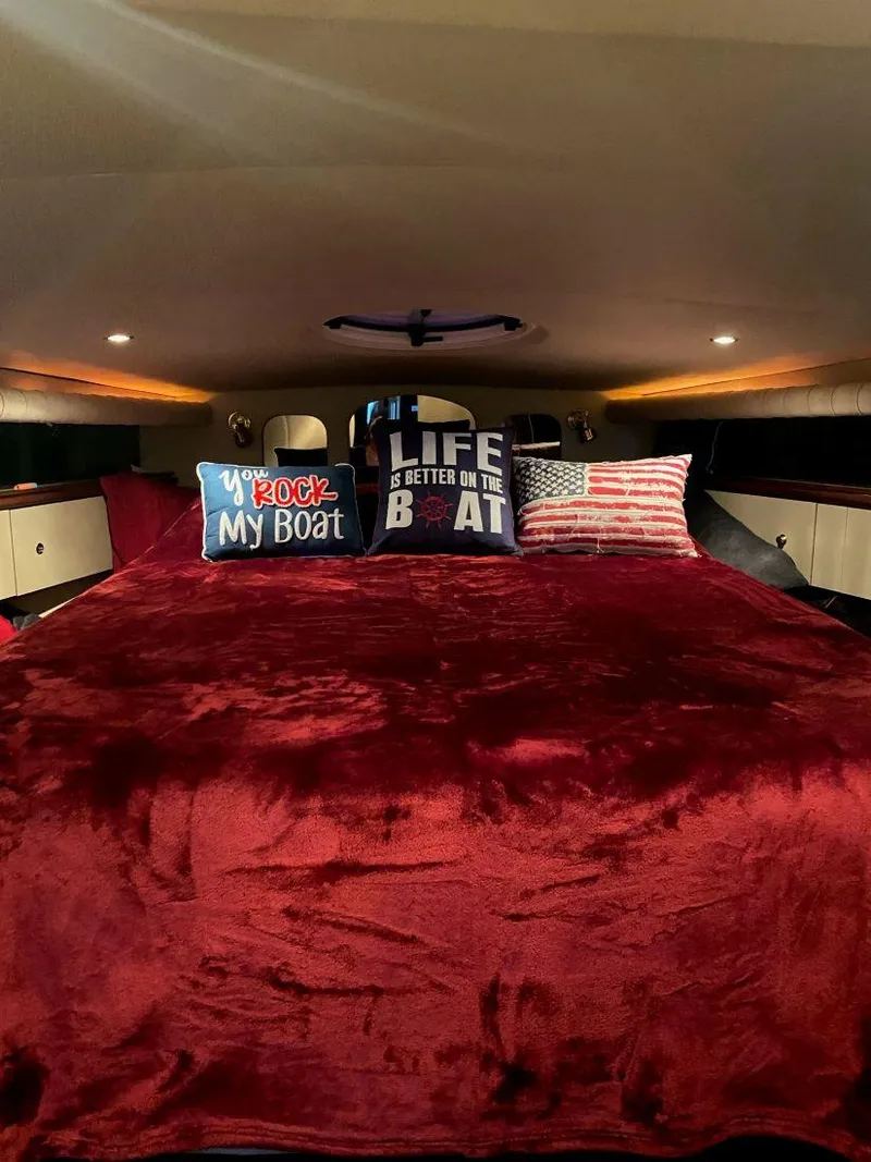 Slide: The Image of Luxurious cabin interior of 2000 Cruisers Yachts 4270 Express with plush bedding and decorative pillows. - 20