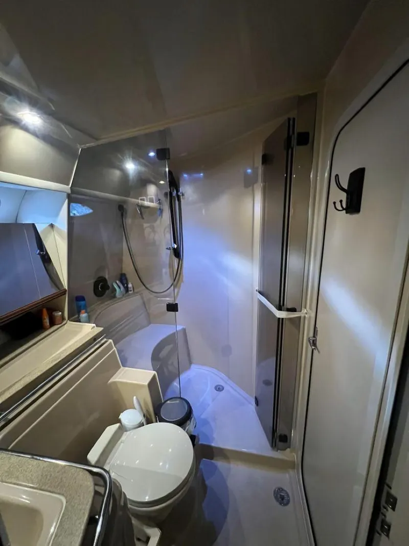 Slide: The Image of Bathroom interior of 2000 Cruisers Yachts 4270 Express, featuring shower and toilet. - 22