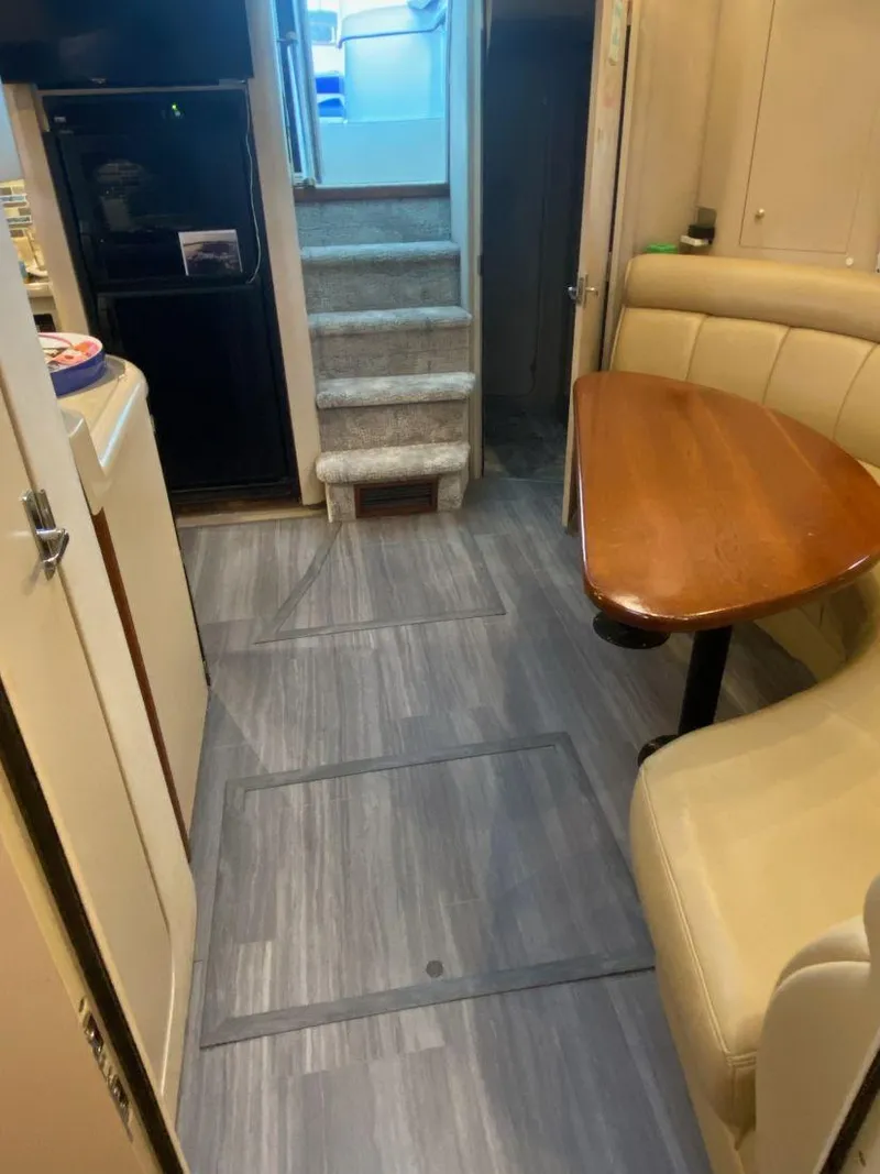 Slide: The Image of 2000 Cruisers Yachts 4270 Express interior with dining area and stairs. - 23