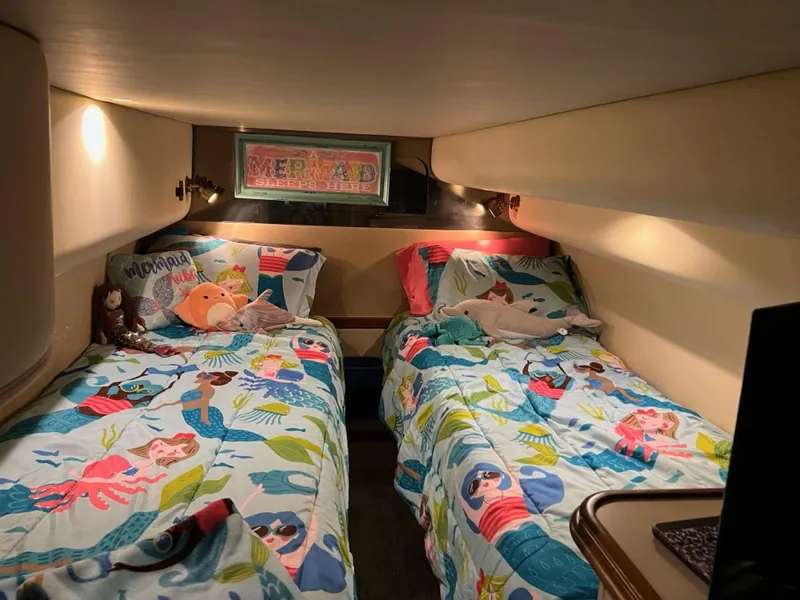 Slide: The Image of Twin beds with colorful mermaid-themed bedding in a 2000 Cruisers Yachts 4270 Express cabin. - 28