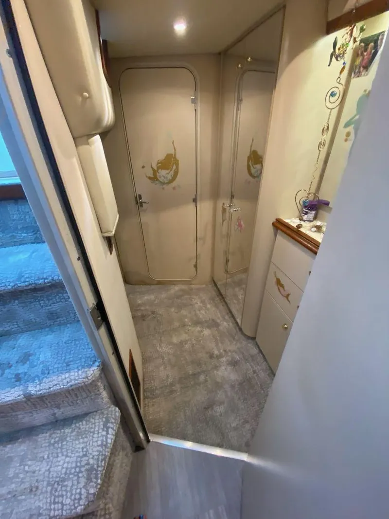 Slide: The Image of Interior hallway of 2000 Cruisers Yachts 4270 Express, featuring carpeted floor and decorative doors. - 32